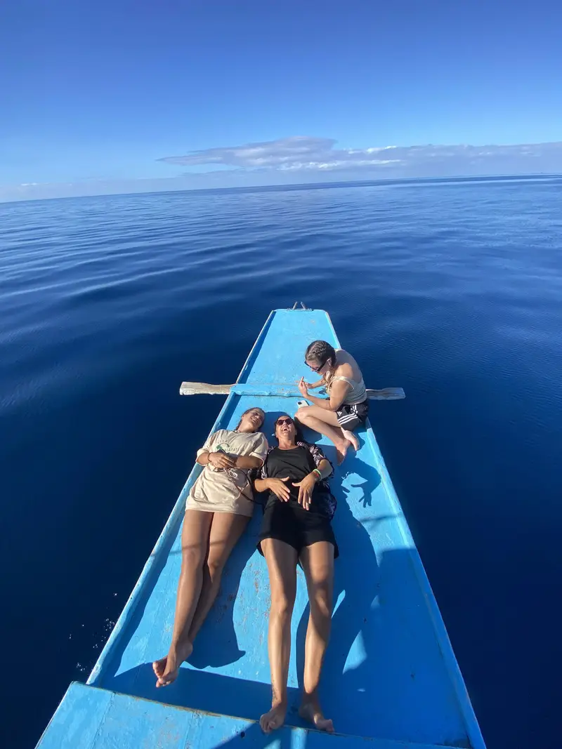 Outrigger bangka crossing flat turquoise water off Bantayan Island on a clear day