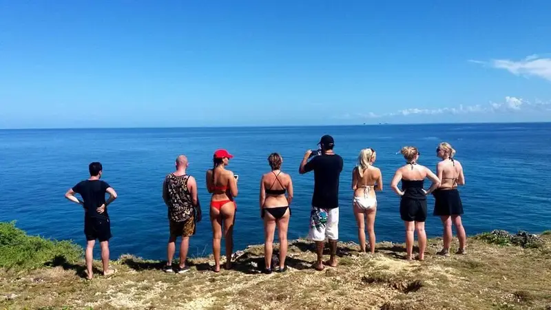 Group standing on a clifftop looking out over the open sea