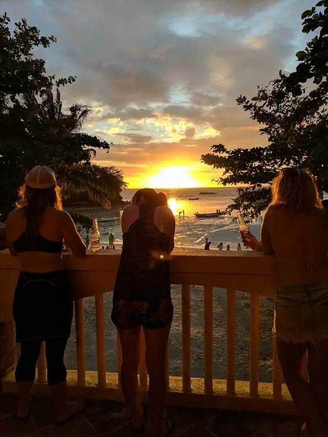 Guests watching the sunset from a beachfront deck at Malapascua
